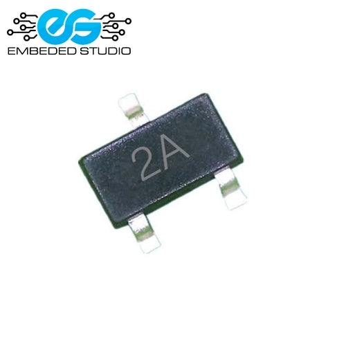 A small black surface-mount electronic component (MMBT3906 SOT-23 transistor) displaying the printed marking "2A" on its top surface, featuring three silver metal leads, set against a plain white background with the Embeded Studio logo watermark in the top-left corner.
