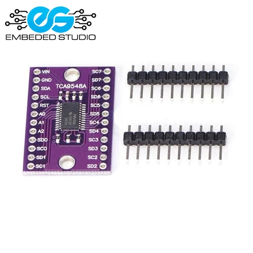 Purple TCA9548A 1-to-8 I2C multiplexer breakout board next to two rows of un-soldered male pin headers, featuring the Embeded Studio logo on a clean white background