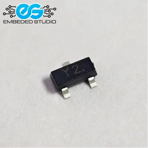 A small black surface-mount electronic component (Y2 SS8550 SOT-23 transistor) displaying the printed marking "Y2." on its top surface, featuring three silver metal leads, set against a plain light background with the Embeded Studio logo watermark in the top-left corner.