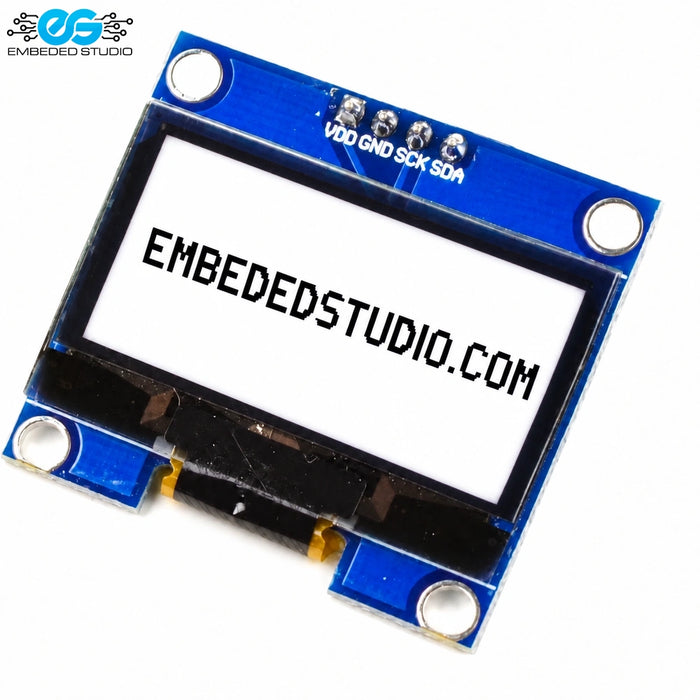 Rear side of a 1.3 inch monochrome OLED display module showing the blue printed circuit board, surface-mount components, 4-pin header soldered connections, and model markings.