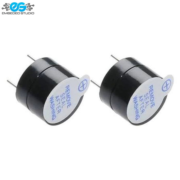 Two 12V active electromagnetic buzzers with protective seal stickers alongside Embedded Studio logo on white background