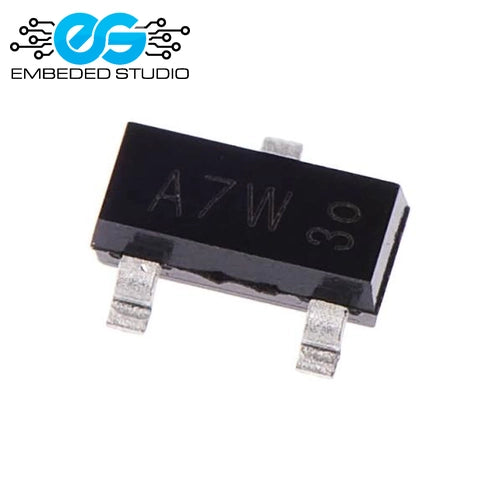 A small black surface-mount electronic component (BAV99 SOT-23 diode) displaying the printed marking "A7W 30" on its top surface, featuring three silver metal leads, set against a plain white background with the Embeded Studio logo watermark in the top-left corner.
