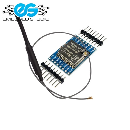 AI-Thinker Ra-02 LoRa module (433MHz) based on the SX1278 chip, mounted on a development breakthrough board with dual-row header pins and connected to an external spring antenna, with an Embeded Studio logo watermark in the top left corner.